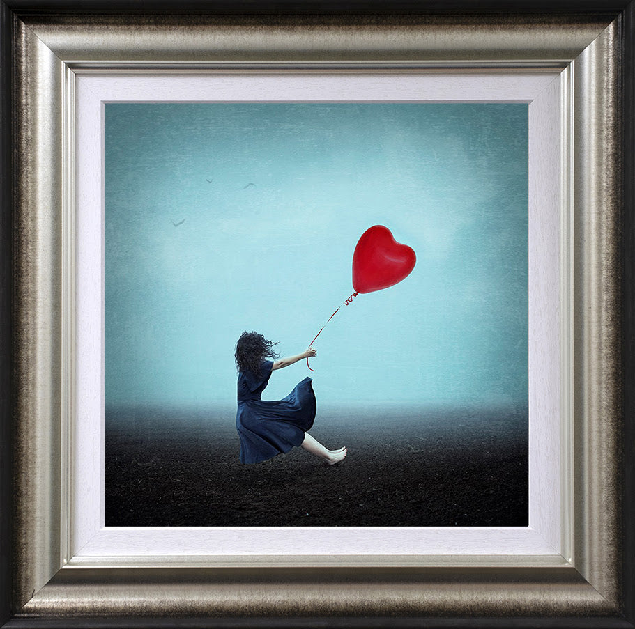 holding onto her heart framed print by artist michelle mackie