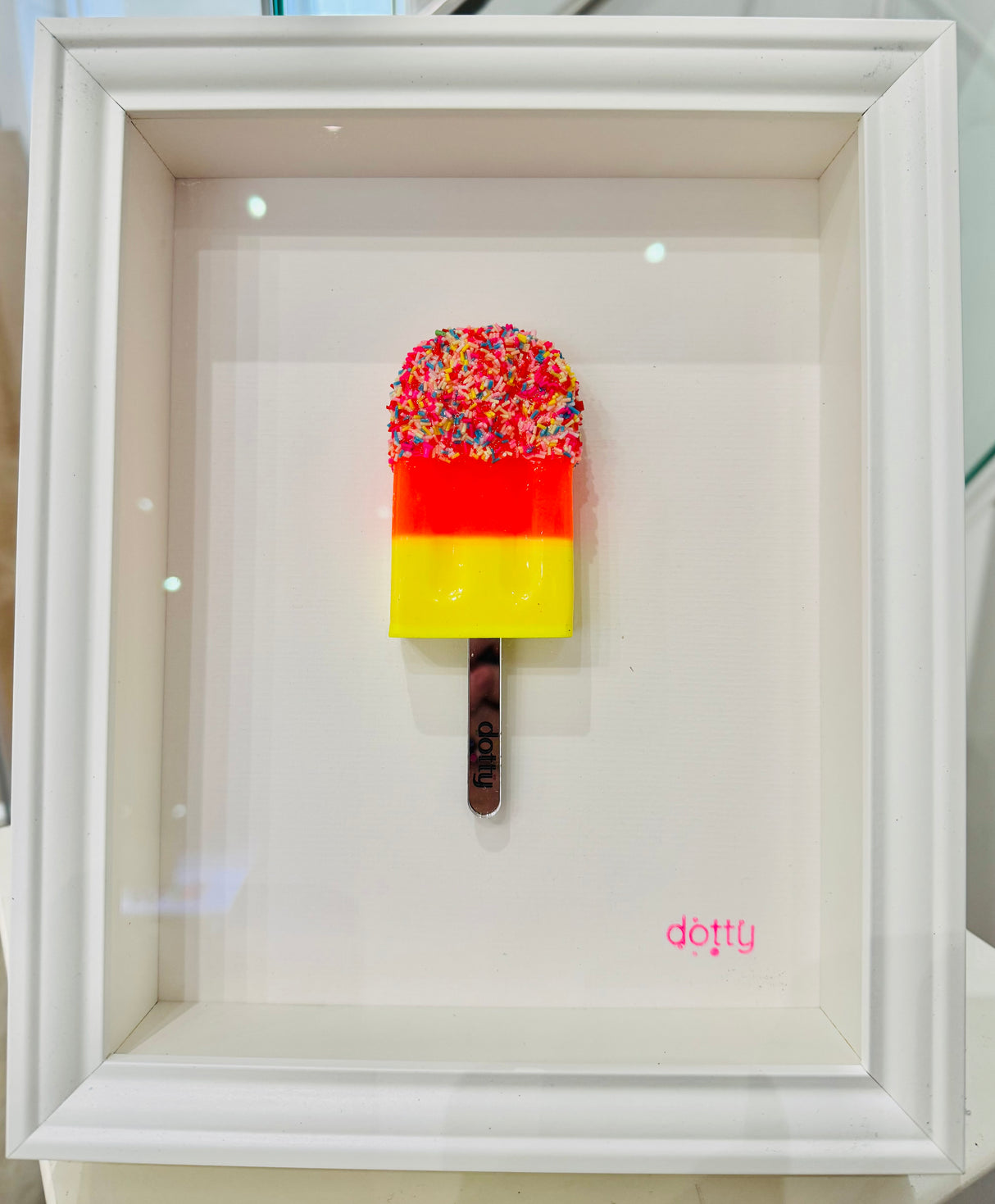 sprinkles original resin lollipop framed by artist dotty